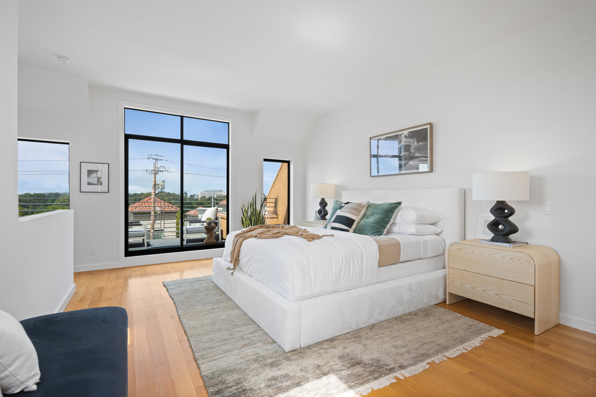 Property Photo: Primary bedroom is the entire upper level of this town home. There is large glass sliding doors that open up to a patio. 