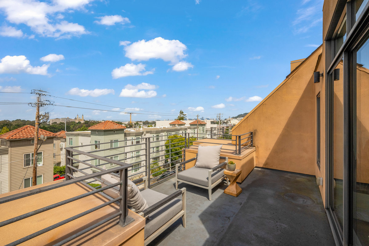 Property Photo: The pation off the primary bedroom has a seating area and looks over Carl Street, 