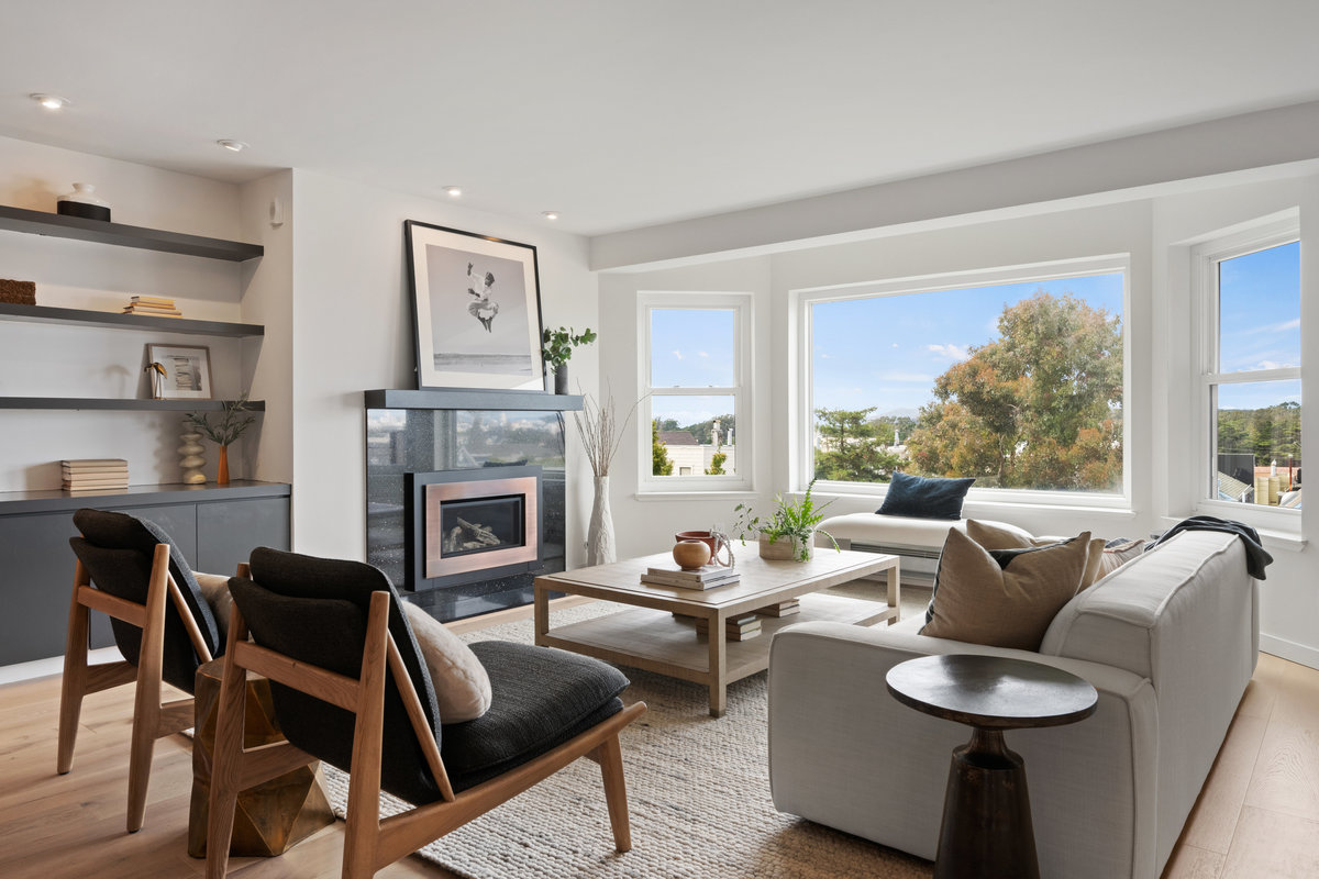 Property Photo: Living room has fireplace and large bay window. 