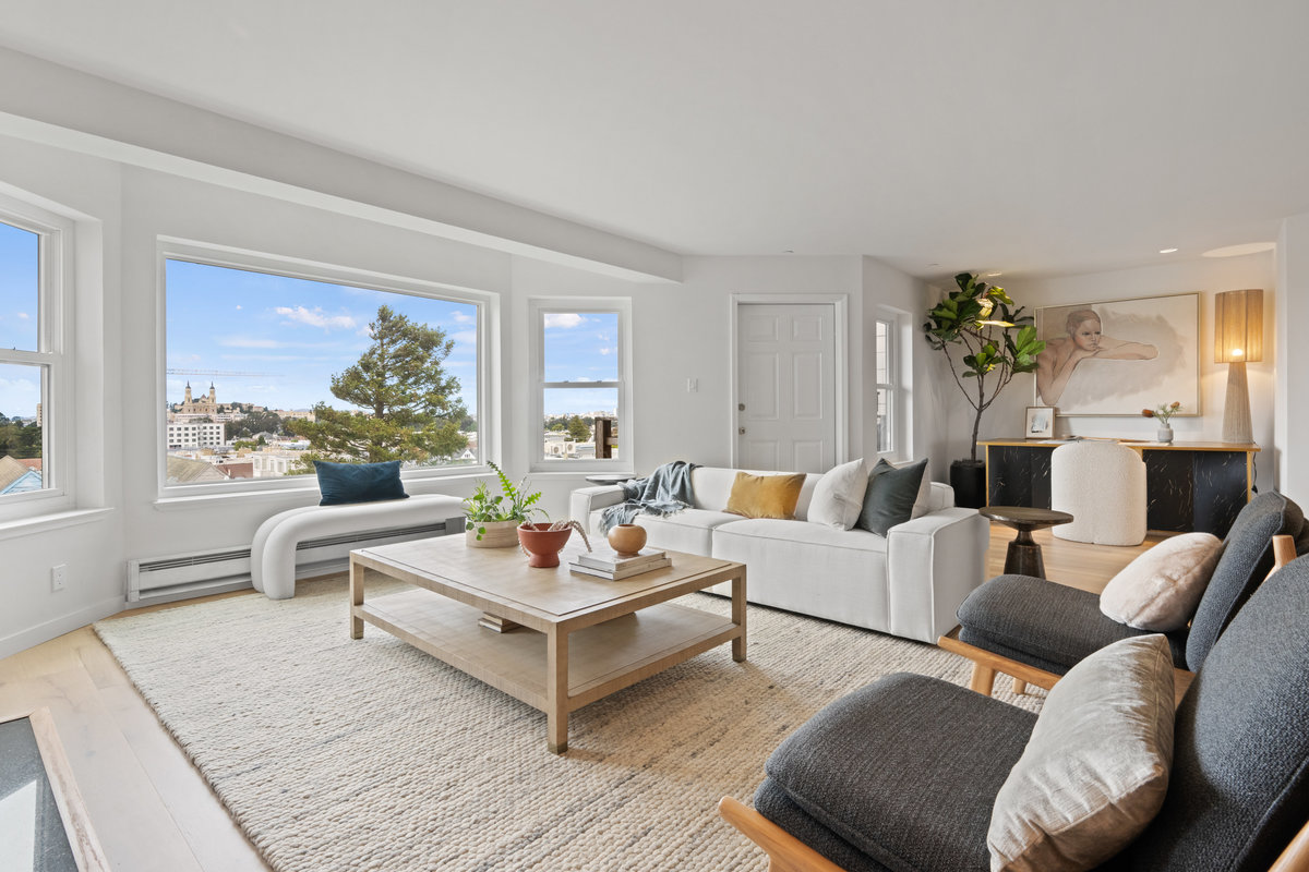 Property Photo: Looking over living room towards the large back bay windows.