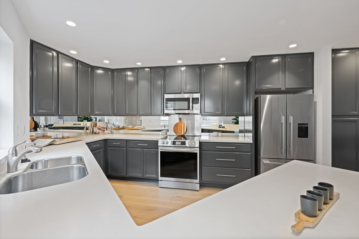 Property Photo: Kitchen has all stainless steel appliances with upper and lower cabinets that are a nice dark great color. 