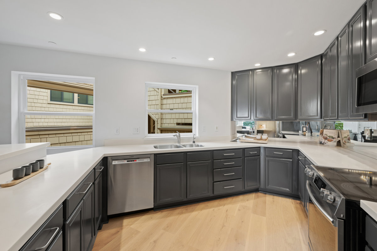 Property Photo: Kitchen sink is right under a window that looking out to courtyard. The dishwasher is right next to sink. 