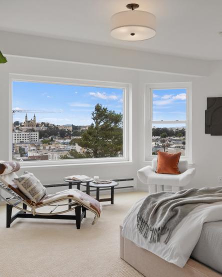 Property Thumbnail: Closer up photo of sitting area with the large windows and blue sky. 