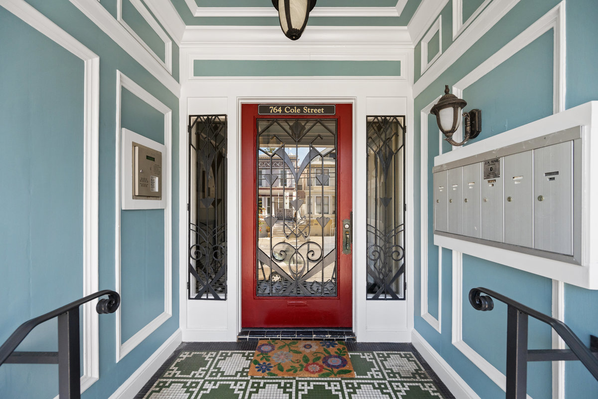 Property Photo: Front entry way of 764 Carl Street. There is lots of molding detail, and red front door. 