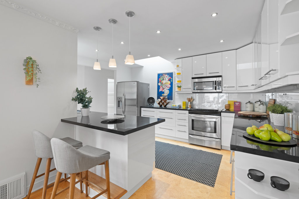 Property Photo: Breakfast bar has 2 stools for seating. There is a skylight that lets in lots of natural light. 