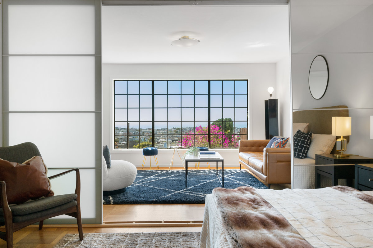 Property Photo: There is a sitting room on the other side of lower bedroom. There is a sliding door that closes off the bedroom. 