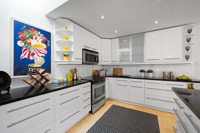 Property Thumbnail: Kitchen has upper open corner shelves and lots of natural light. 