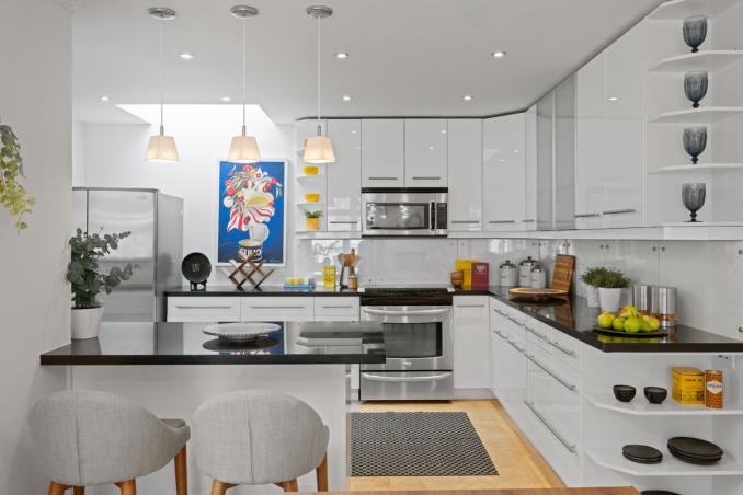 Property Thumbnail: Kitchen is recently updated with stainless steal appliances. The cabinets are white and countertops are dark stone.