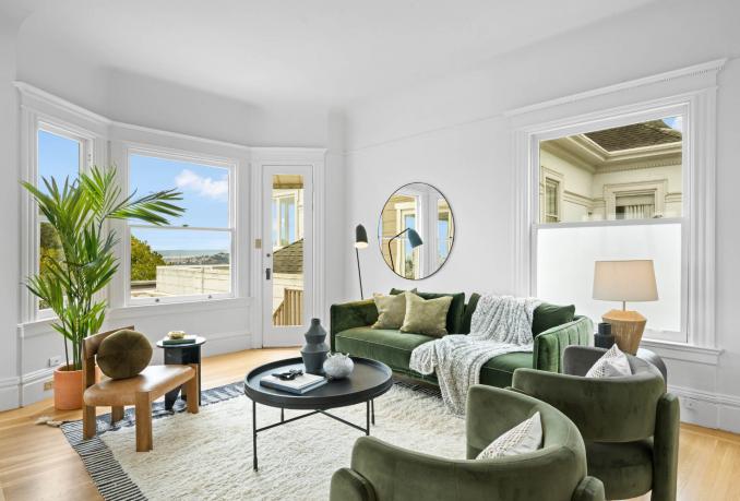 Property Thumbnail: Living room has nice large sage color couch with two plush chairs, and small round coffee table. 