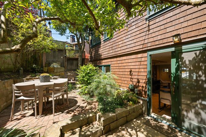 Property Thumbnail: There is a small round table in the back yard. 