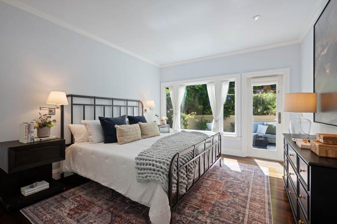 Property Thumbnail: First upper level bedroom has large window that looks out to the back yard and has a door that opens to back yard. 