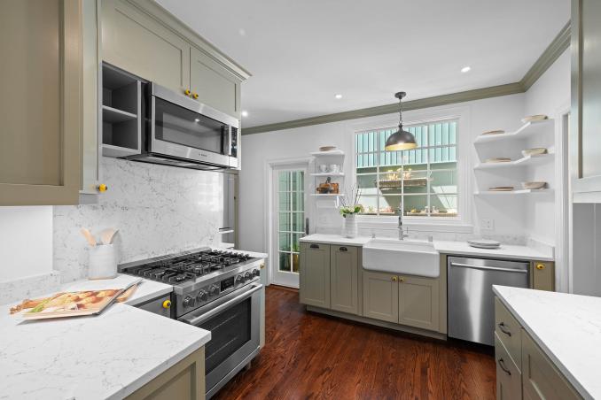 Property Thumbnail: Kitchen has a farmers sink with a large window and door that leads to the lower tradesman entrance. 