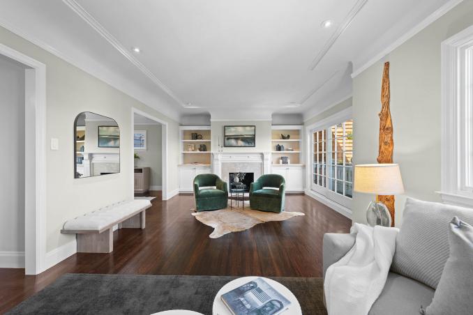 Property Thumbnail: Looking over the living room from the couch looking towards the fireplace. Moldings are beautiful and there is recessed lighting. 