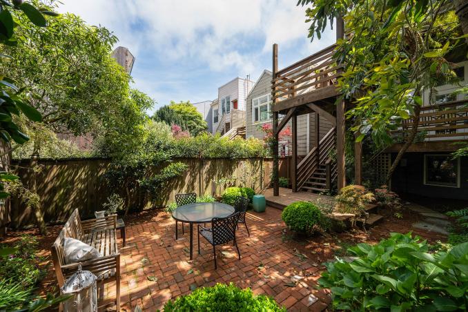 Property Thumbnail: There is a small table and bench in the back yard.