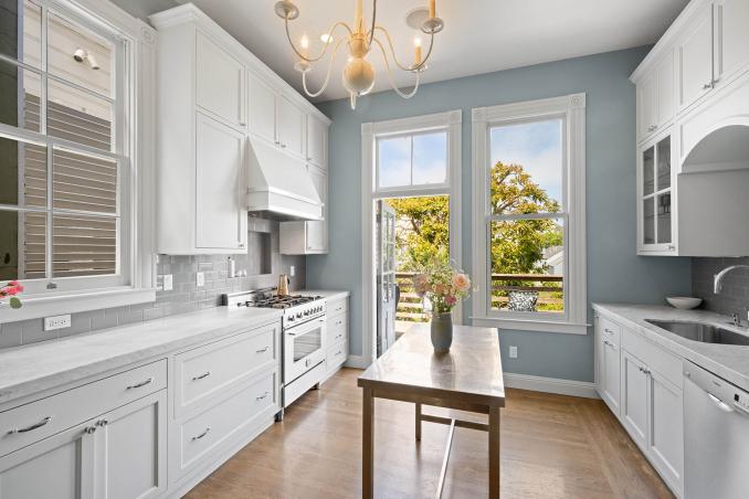 Property Thumbnail: There are white cabinets and natural stone countertops. 