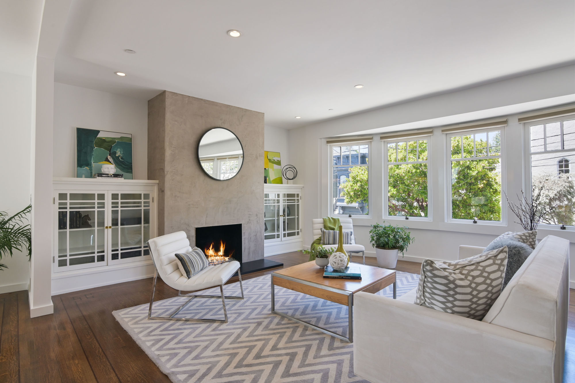 Property Photo: View of a living room, with fireplace and built-in glass front cabinets 