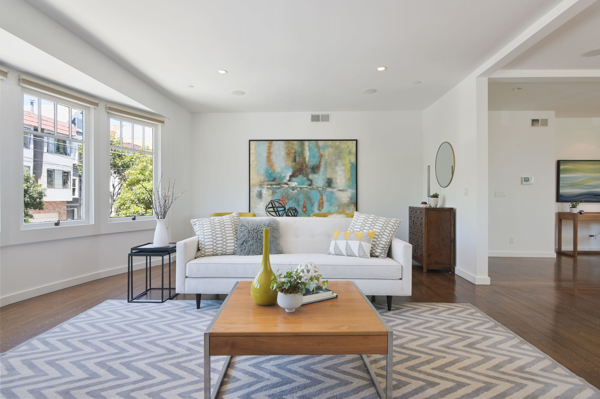 Property Photo: Living room, featuring wood floors and large windows