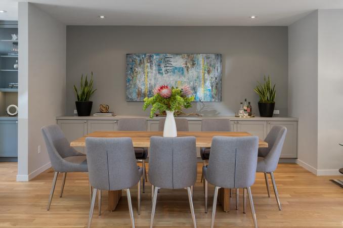 Property Thumbnail: Dining area with wood floors and light grey cabinetry 