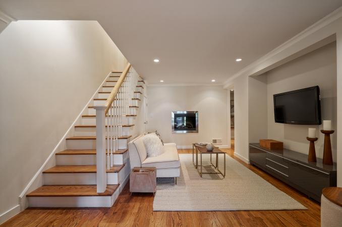 Property Thumbnail: Lower level living area and wood stairs leading up