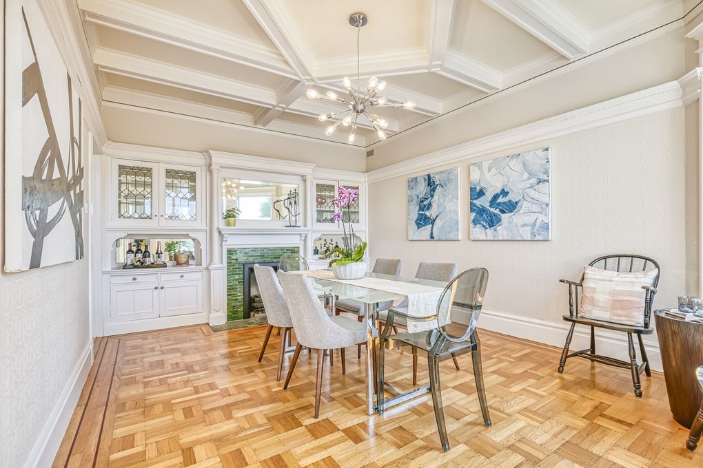 Property Photo: Formal dining room with wood floor and boxed ceiling 