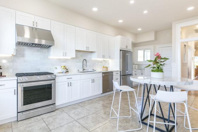 Property Thumbnail: View of the kitchen, featuring tile floors and white cabinets