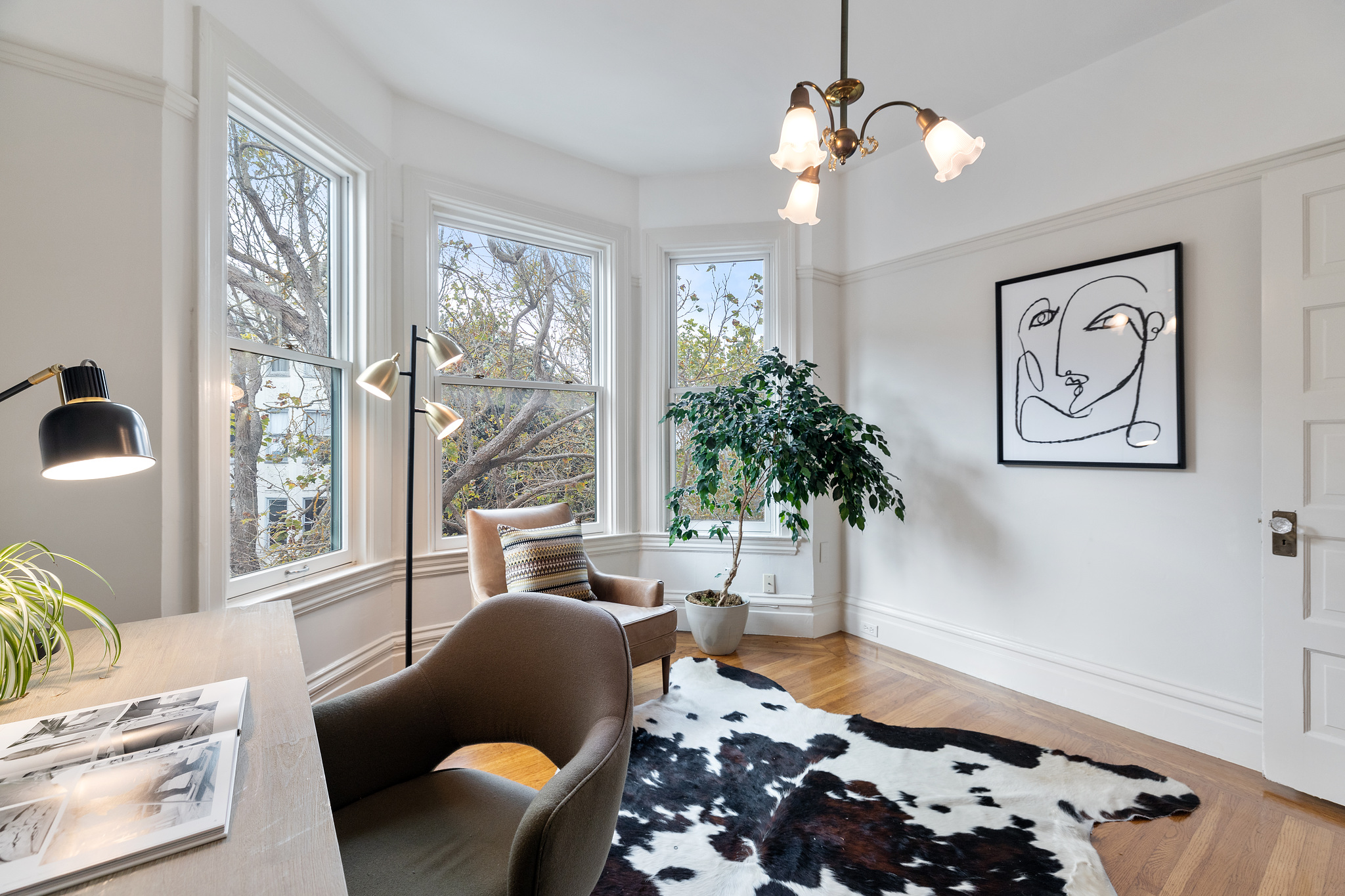 Property Photo: Large windows and artwork adorn the walls of 726 Clayton Street