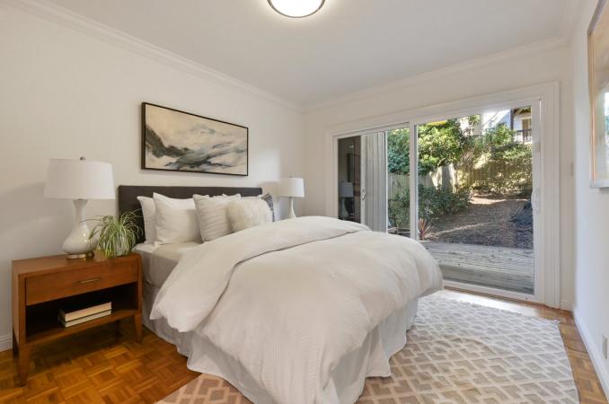Property Thumbnail: Lower unit bedroom with a walk-out door to the rear yard and deck