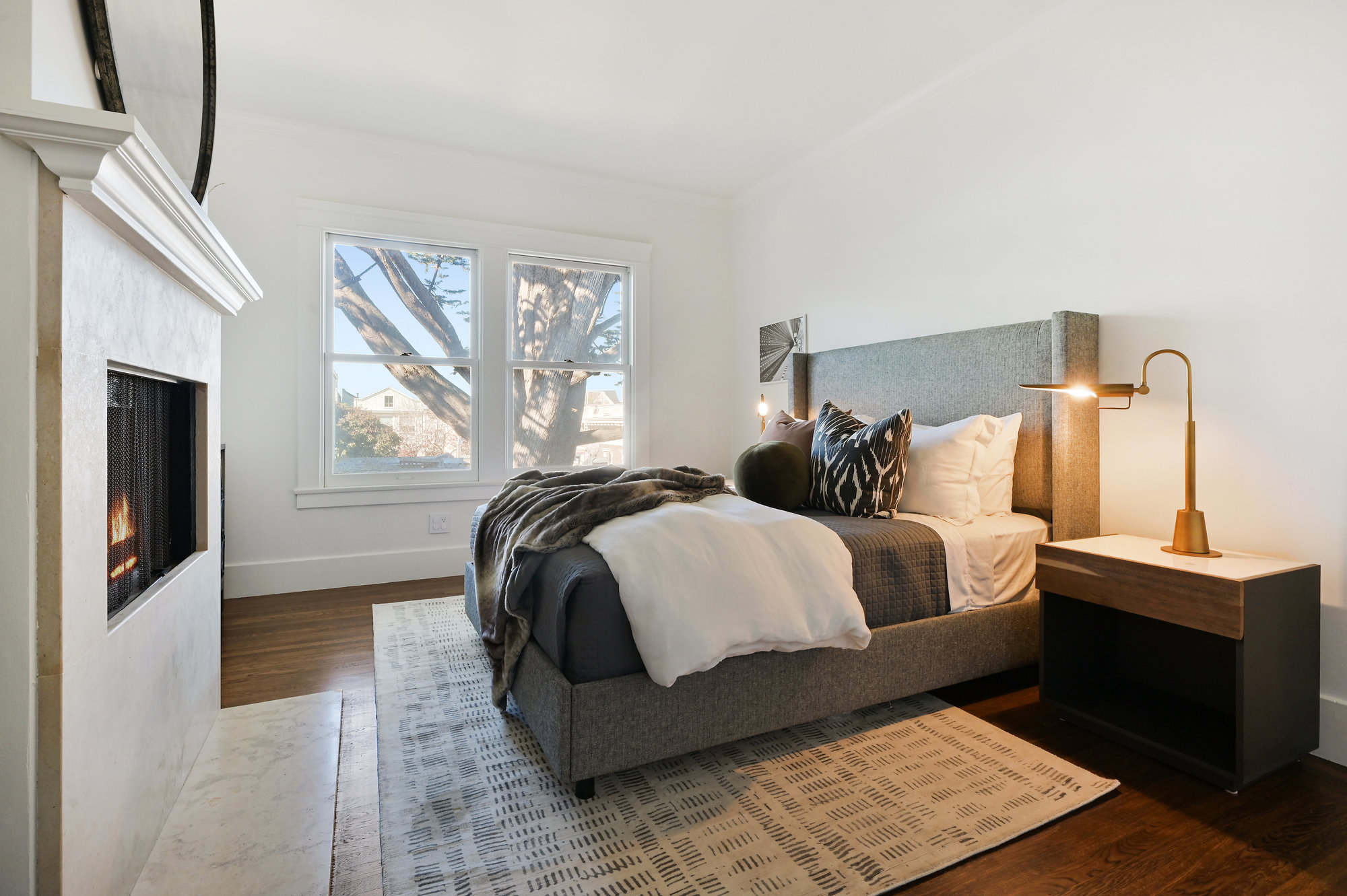 Property Photo: Bedroom featuring large windows and wood floors