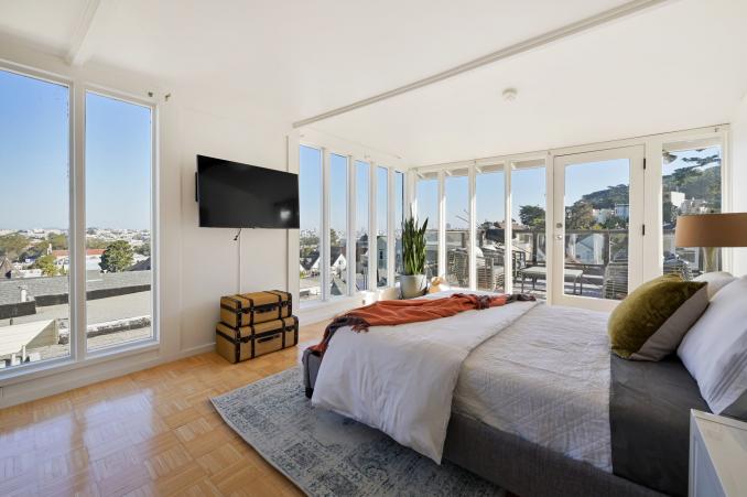 Property Thumbnail: View of the third bedroom at the top of the house, featuring two walls of windows