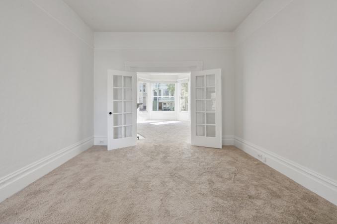 Property Thumbnail: Long view of a living area, featuring french doors