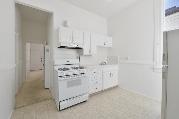 Property Thumbnail: A kitchen with white cabinets and stove