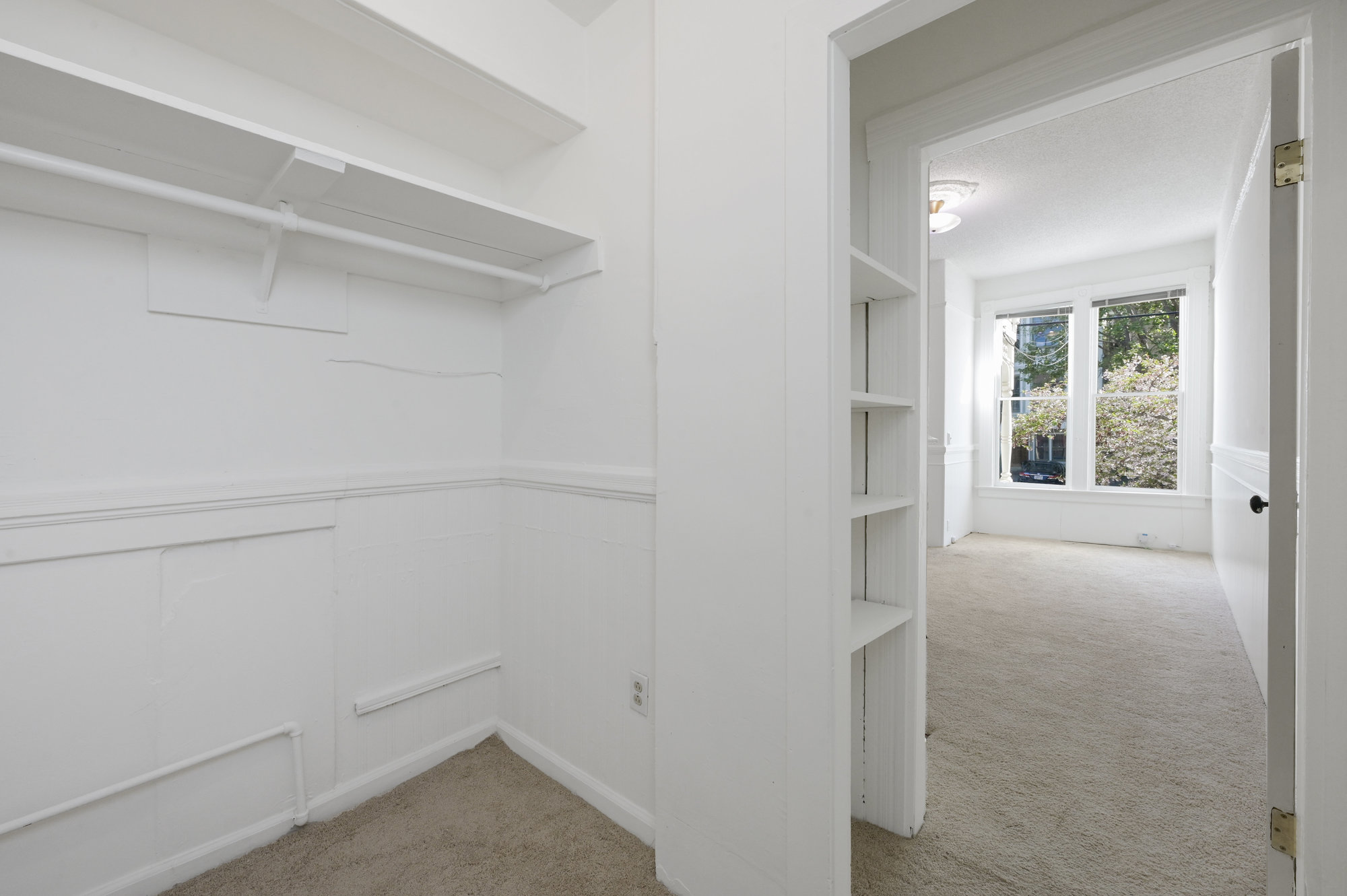 Property Photo: View of a walk-in closet with plenty of storage space