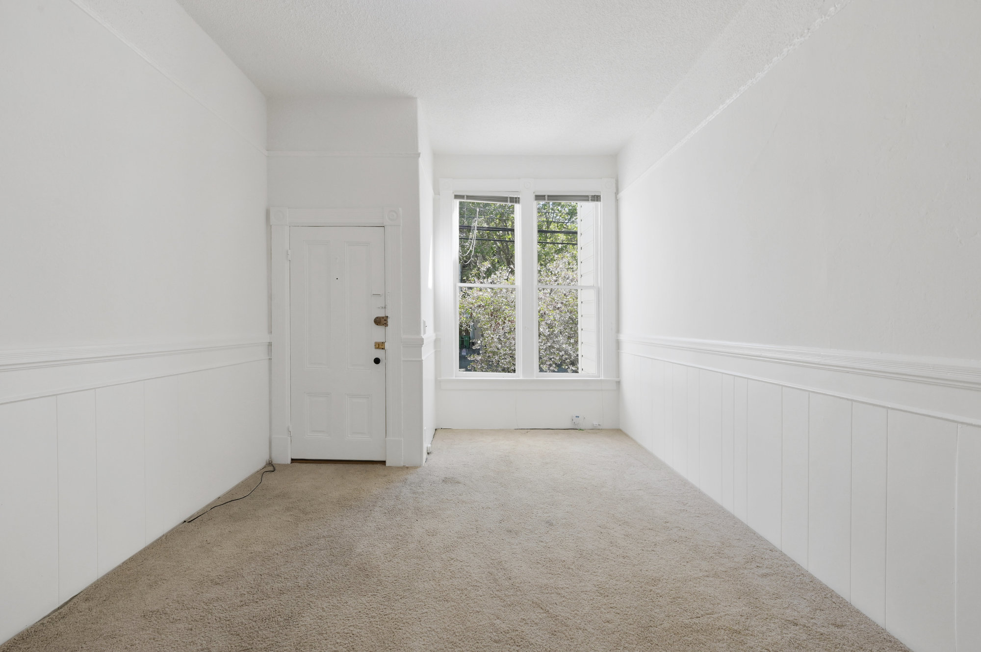 Property Photo: View of a living area, featuring two large windows