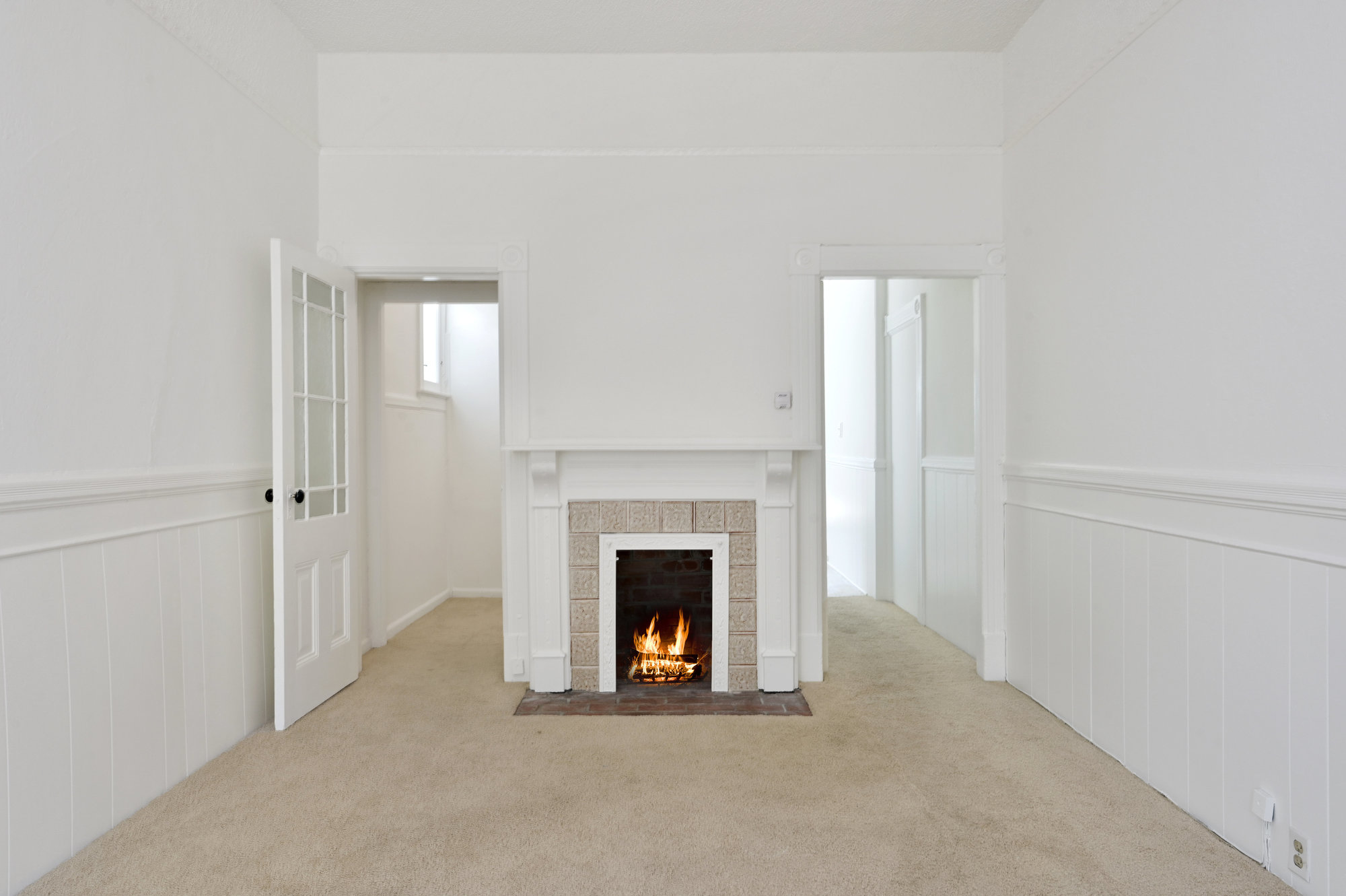 Property Photo: View of a second living room with a fireplace and white mantle