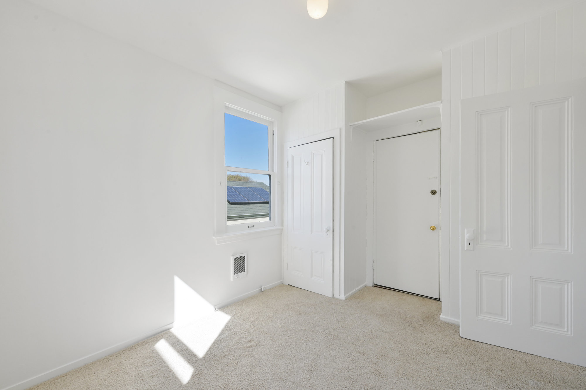 Property Photo: Room with two closets and a large window