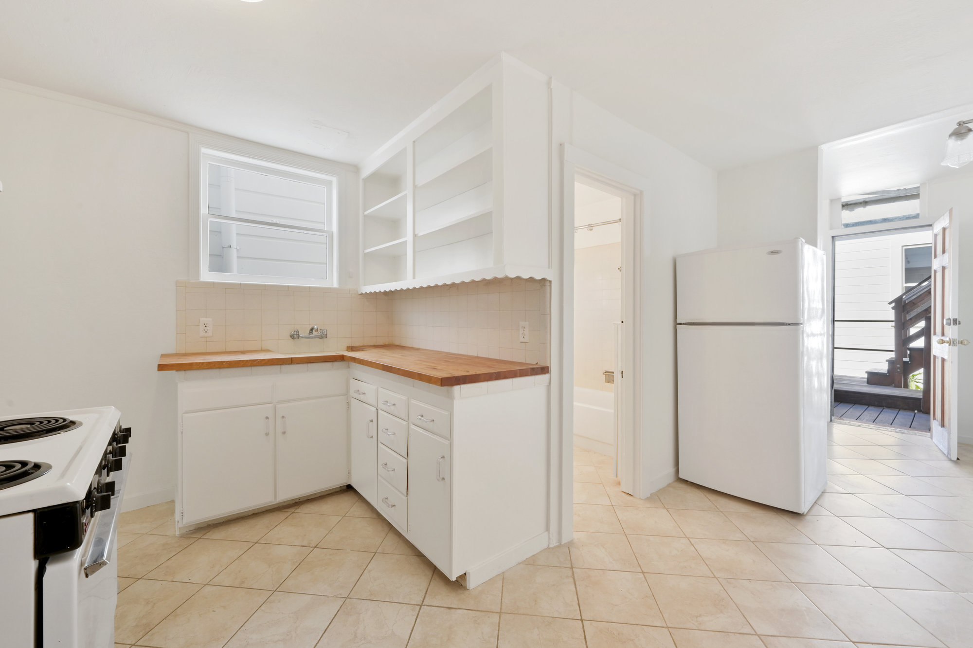 Property Photo: Kitchen, featuring white cabinets
