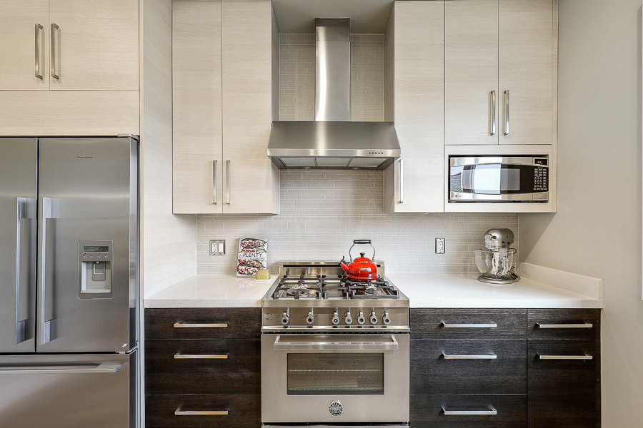 Property Photo: Close-up of the kitchen, featuring a stainless steel stove and fridge