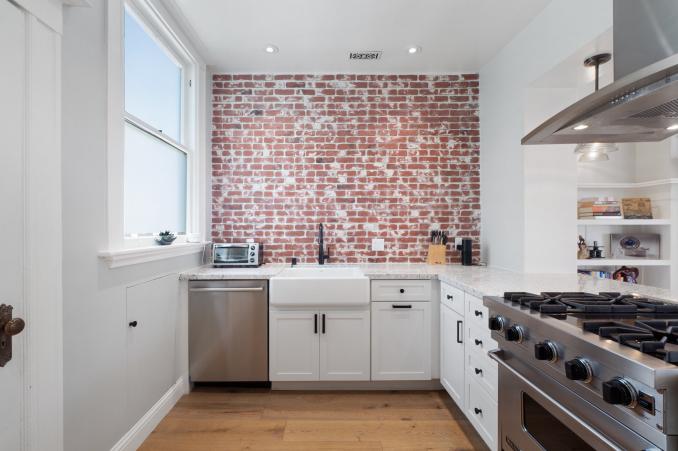 Property Thumbnail: Kitchen with exposed brick wall, showing a farmhouse sink