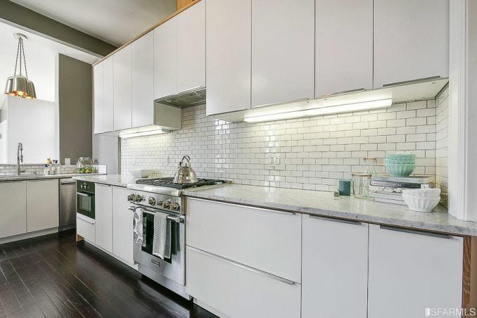Property Thumbnail: Kitchen, showing white cabinetry and dark flooring 