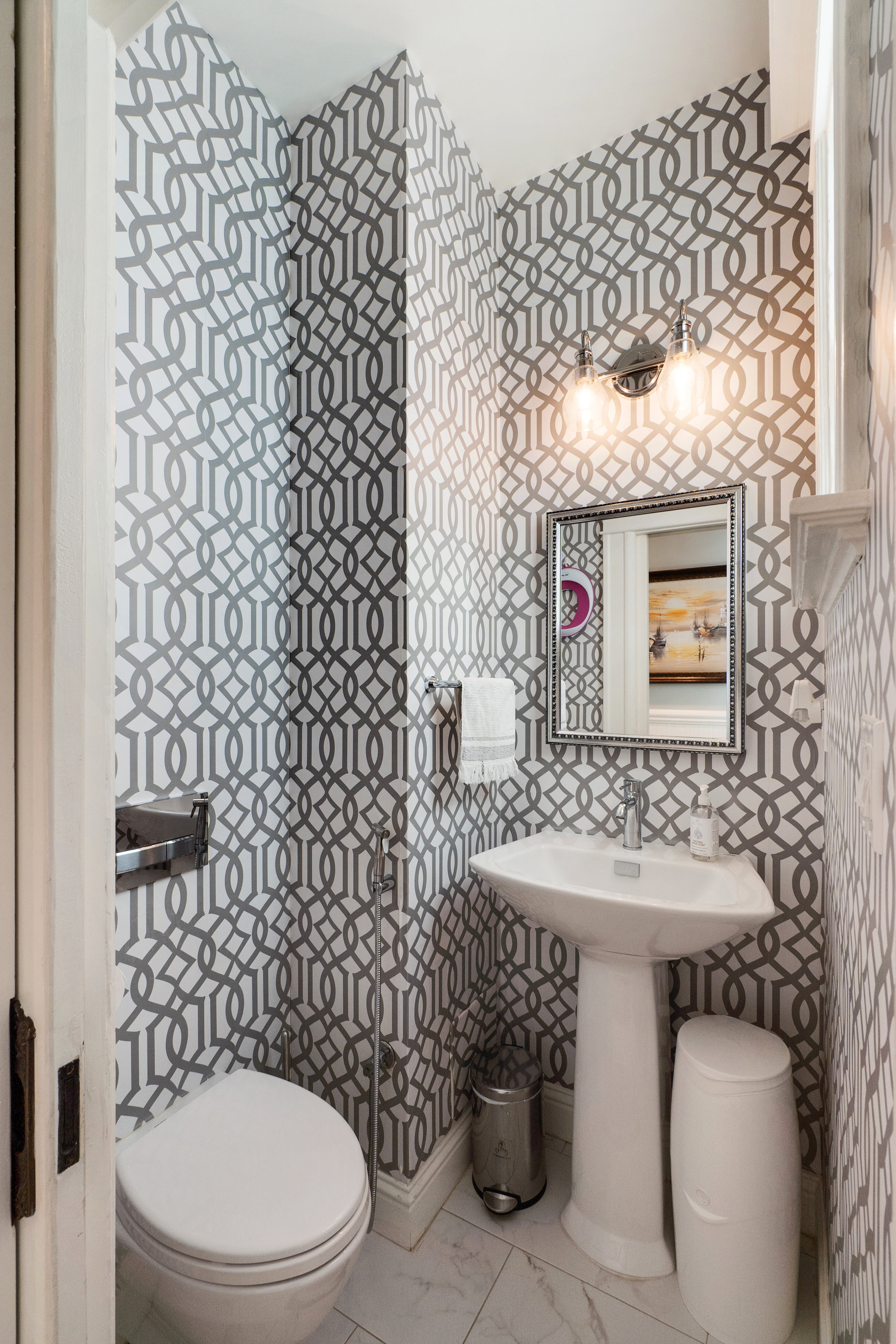 Property Photo: View of bathroom two, featuring modern black and white wall paper