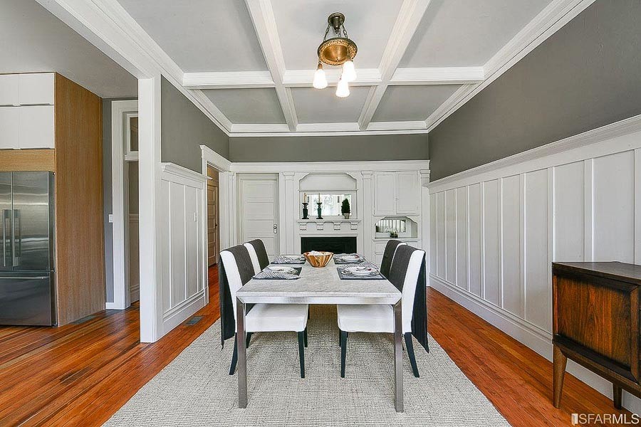 Property Photo: Formal dining room with boxed ceilings, wood floors and fireplace