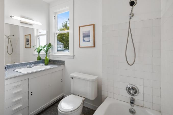 Property Thumbnail: Bathroom with bath tub, a window, and vanity