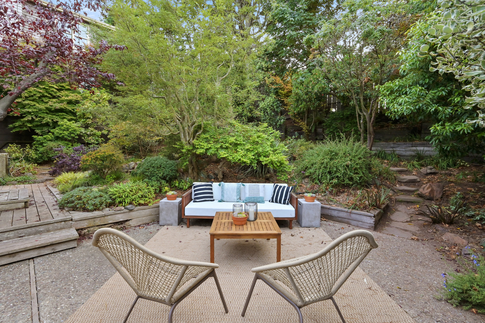 Property Photo: Outdoor living area with steps leading through the lush, mature garden