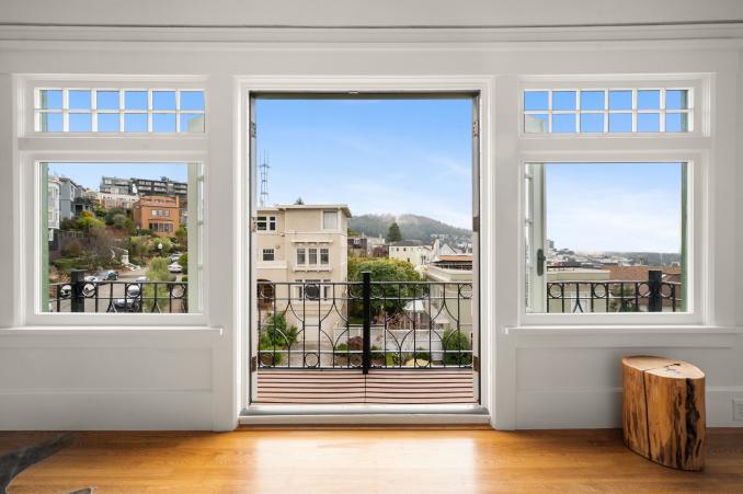 Property Thumbnail: Open French doors showing the balcony adjacent to the primary bedroom