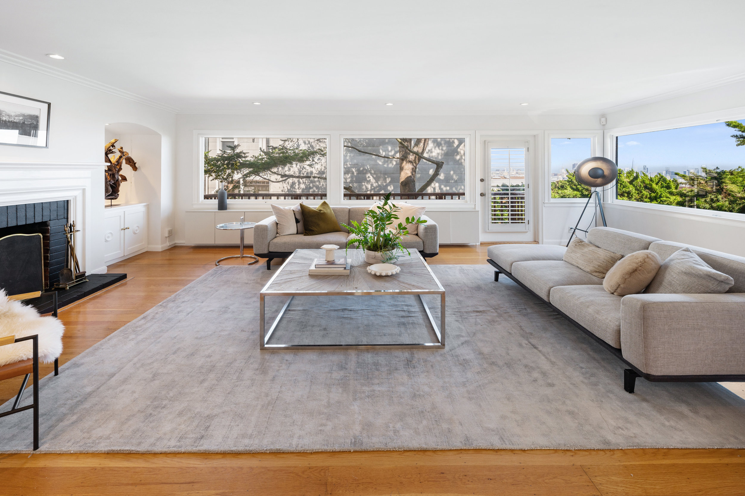 Property Photo: Side-view of the living room showing wall-to-wall- windows on two sides