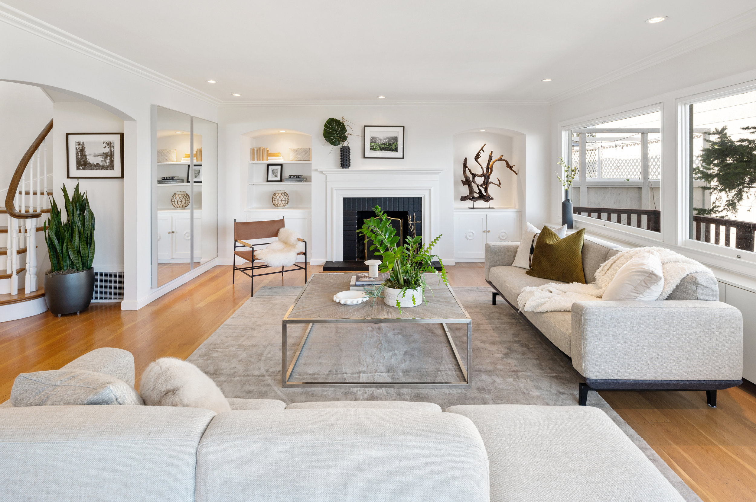 Property Photo: A large living room with wood floors and fireplace