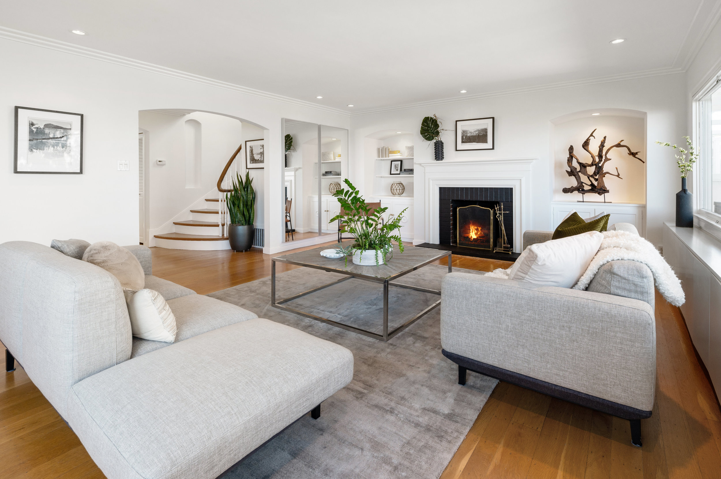 Property Photo: Side-view of the living room, showing an arched door-way and built-in cabinetry