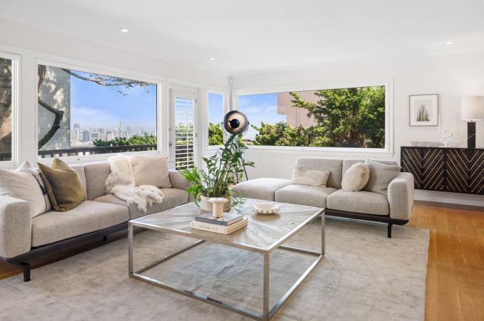 Property Thumbnail: Living room with large windows and views of downtown San Francisco