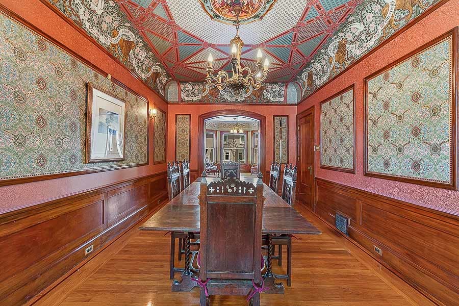 Property Photo: Dining room, featuring an elaborate ceiling with crown moulding 