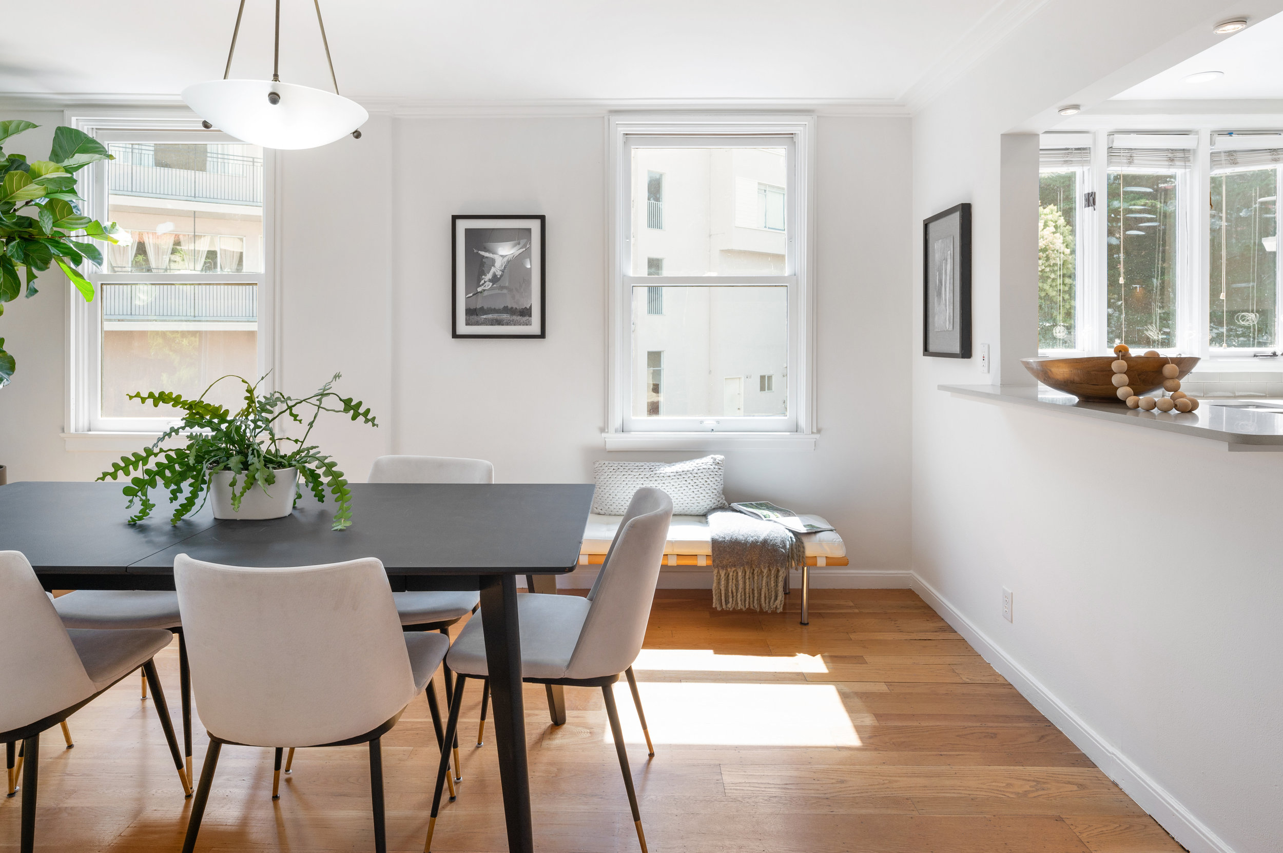 Property Photo: Dining area with sunlight streaming in the windows